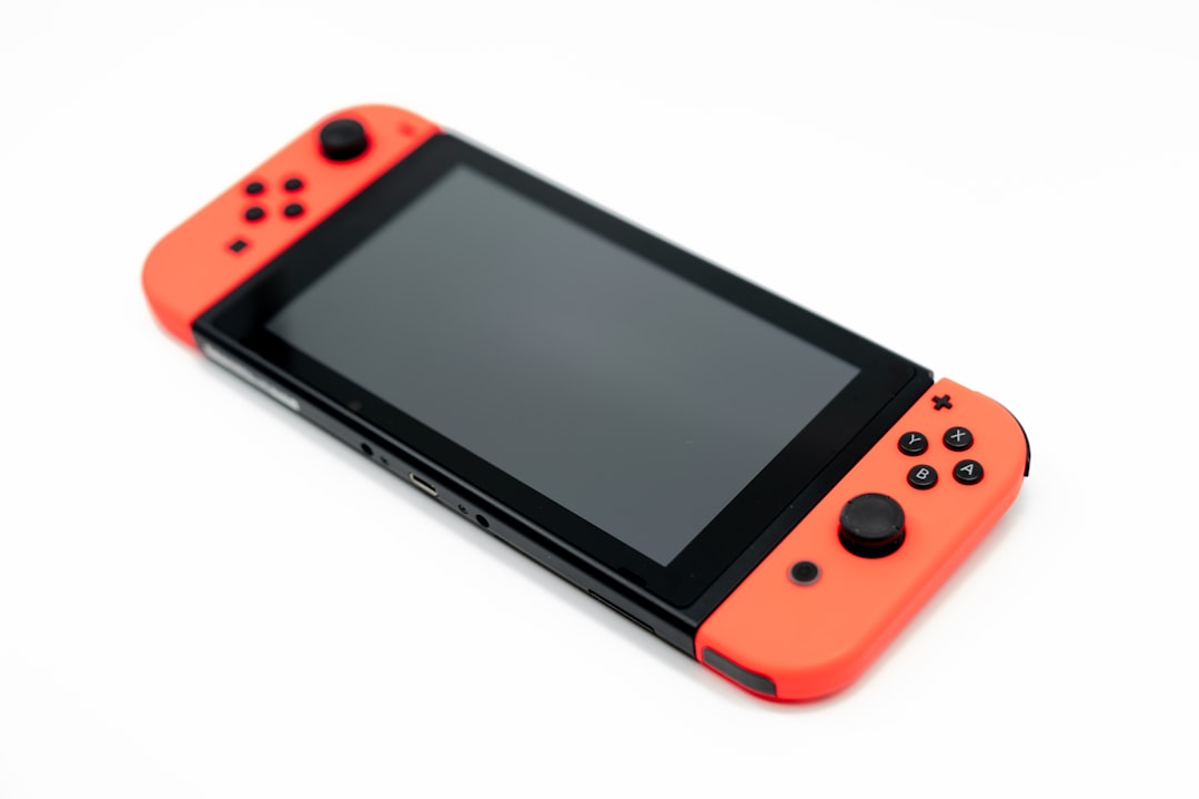 A hand holding a Nintendo-era cartridge, yellowed label catching lamp light