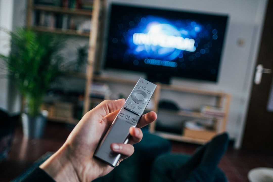 A dim living room with a CRT television glowing, a controller resting on the couch